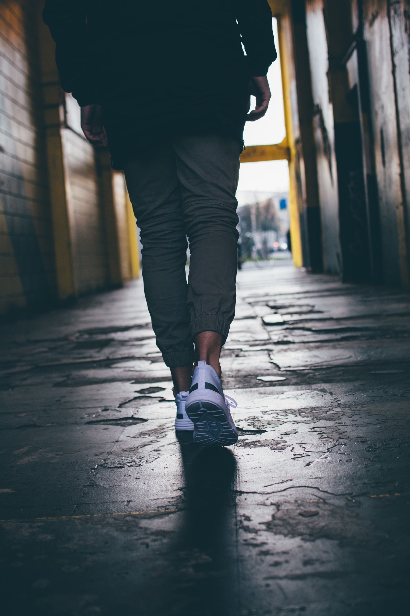 Person walking in white ARKK sneakers