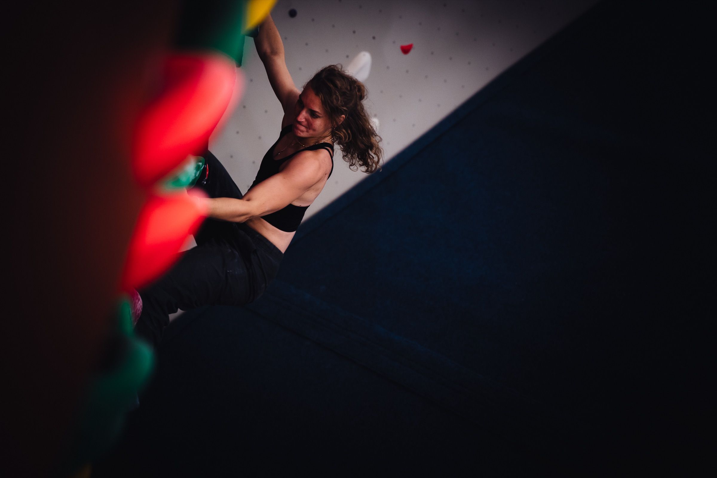 Climbing action on an overhang in the bouldering gym
