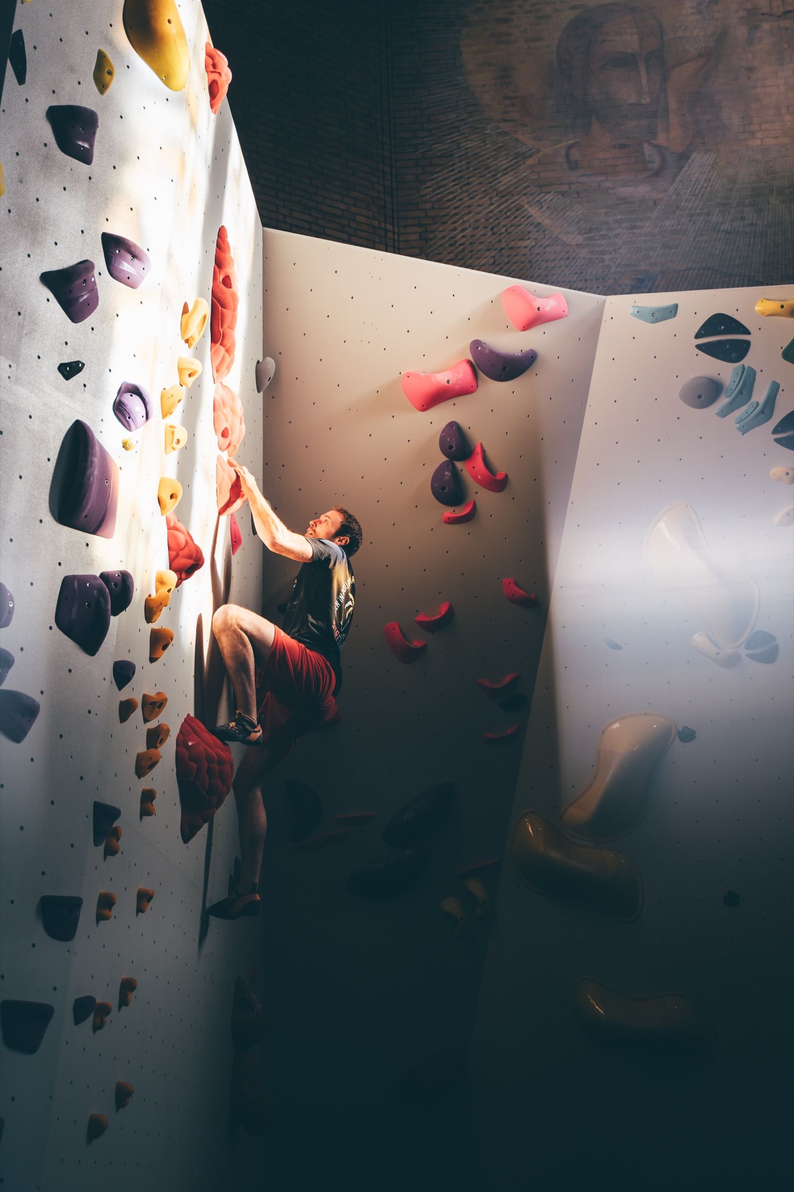 Man climbing beneath the vaulted ceiling of the former church gym
