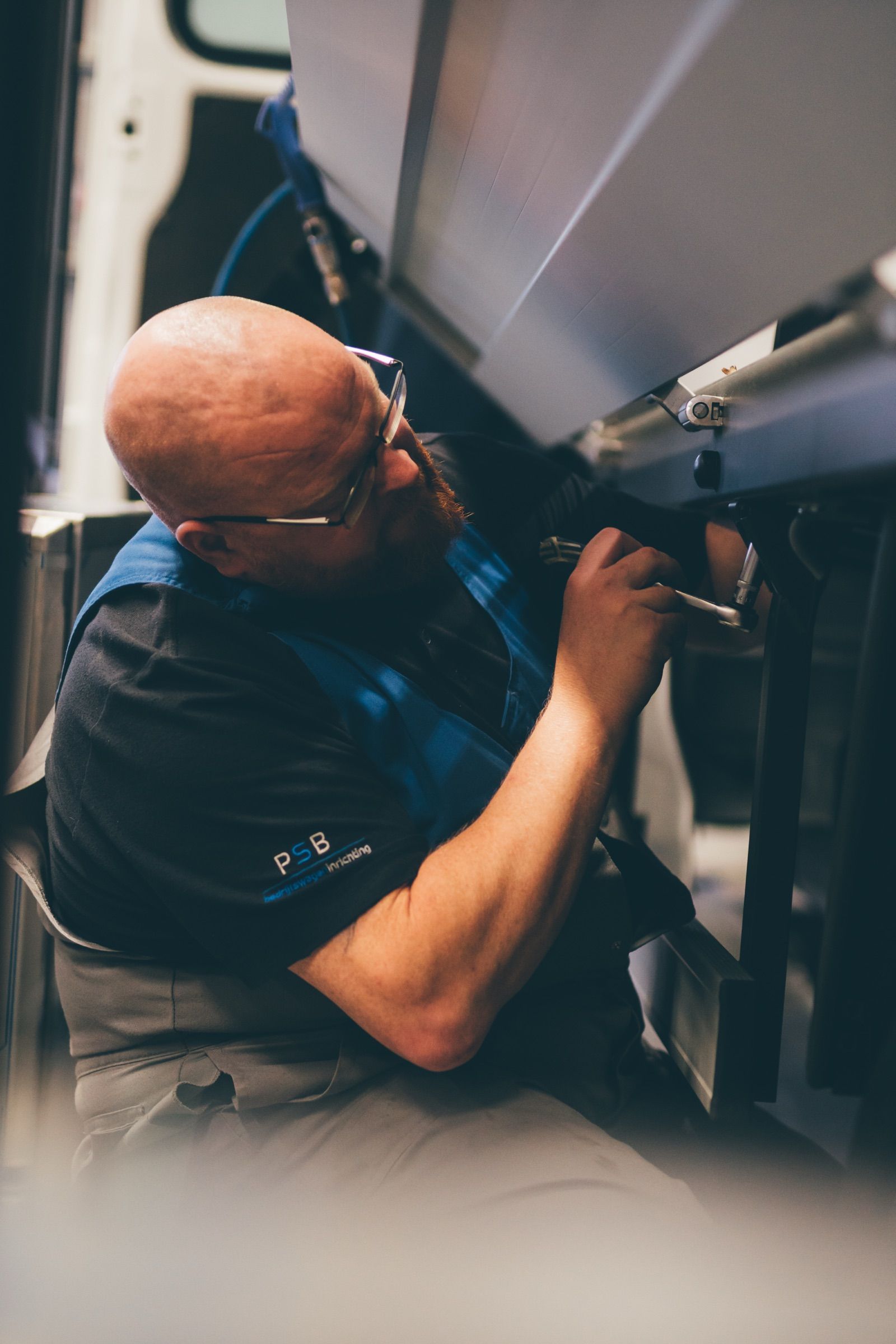 Technician working underneath a vehicle