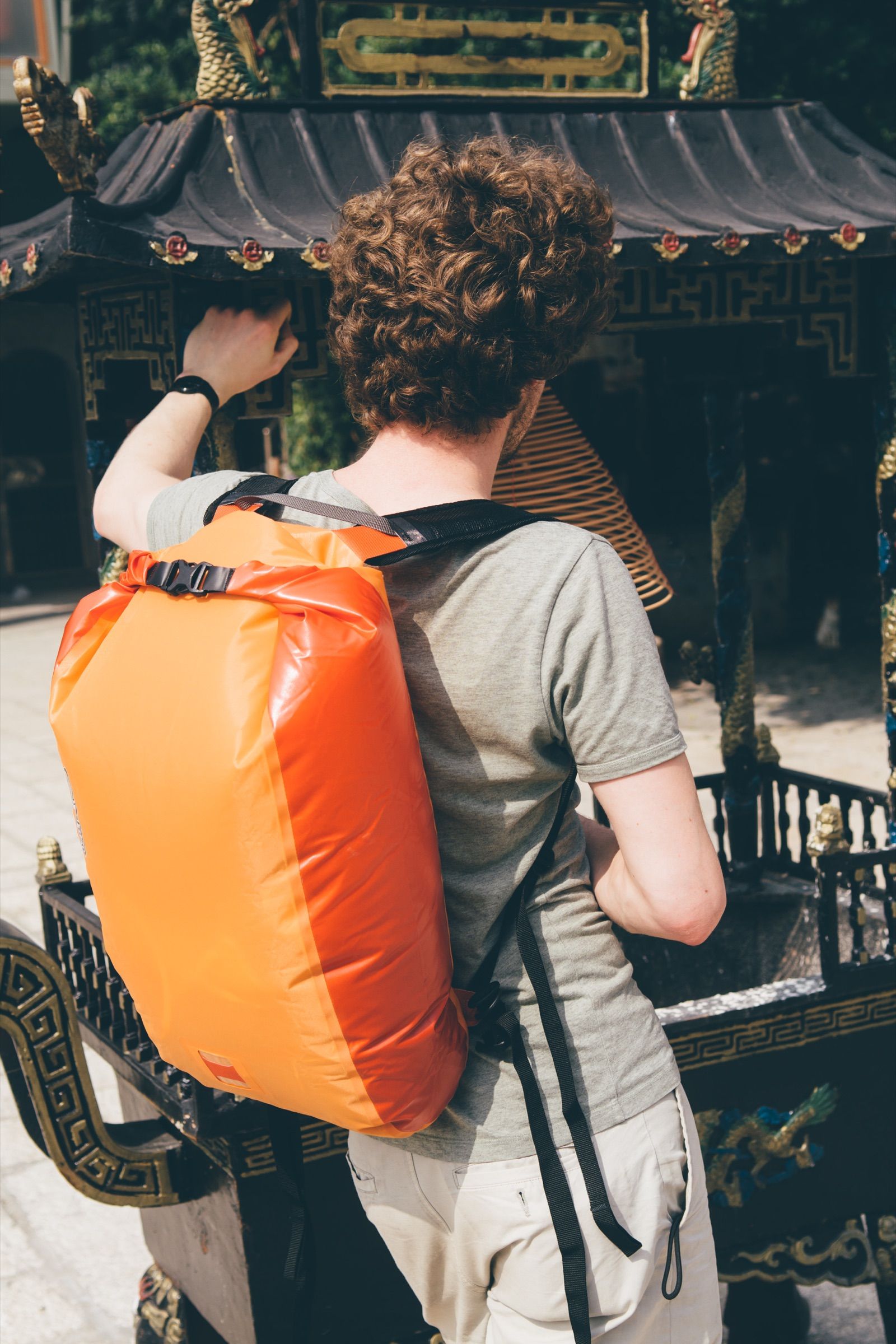 Traveler standing in the street with an Ortlieb backpack