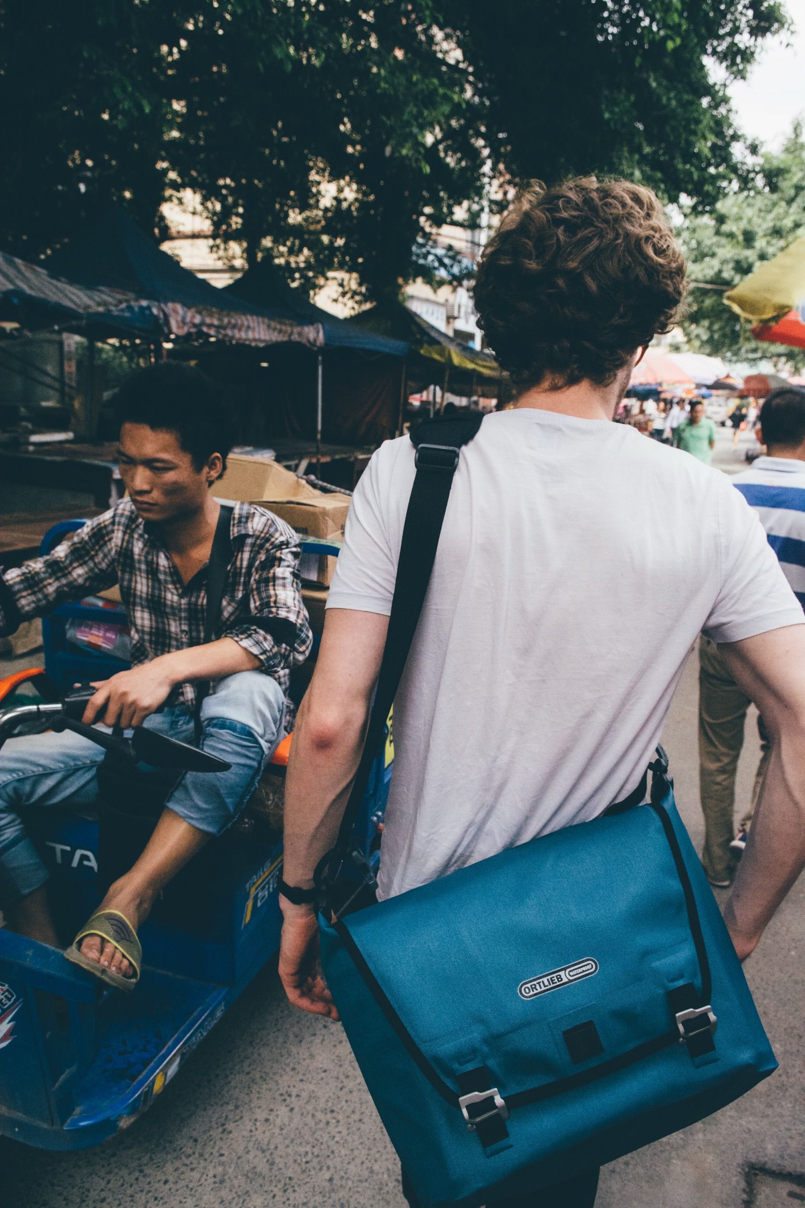 Street scene with a traveler carrying an Ortlieb backpack